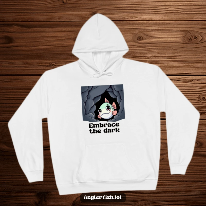Funny anglerfish hoodie illustrating a curious anglerfish peeking from a dark cave, designed for comfort and a humorous touch.