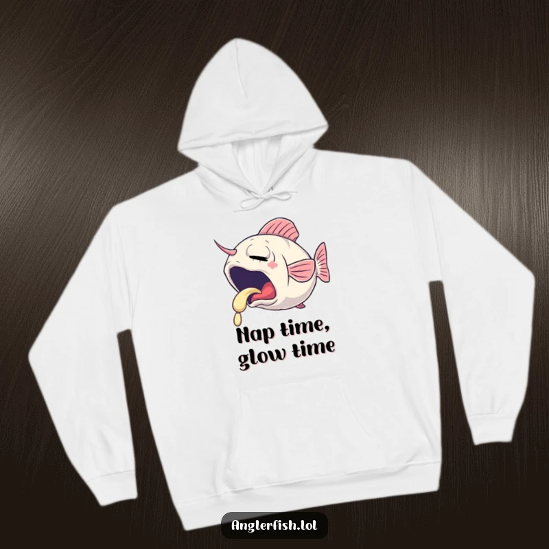 Funny hoodie featuring a sleepy anglerfish yawning, its lure emitting a gentle, soft glow, perfect for cozy relaxation.