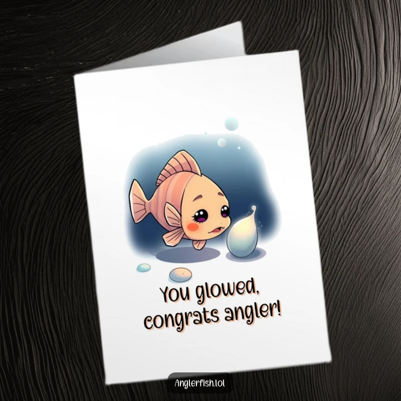 Funny free printable anglerfish congratulations card, a curious fish investigating a shimmering object in the dark.
