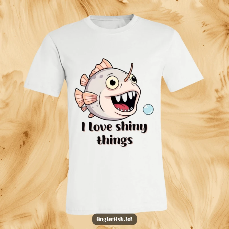 Funny anglerfish t-shirt featuring a gaping, joyful mouth comically in pursuit of a tiny bubble, radiating humor.